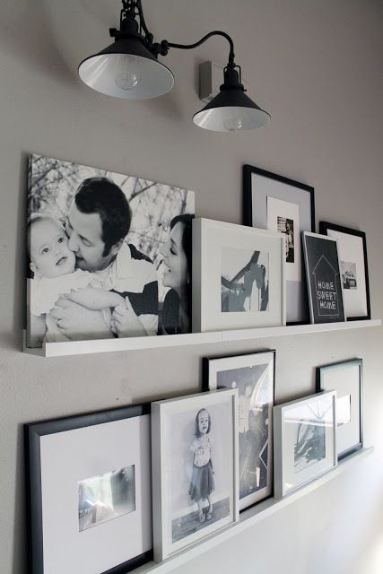 white ledges holding black and white artwork and family photos are a cool and comfortable solution for styling a space