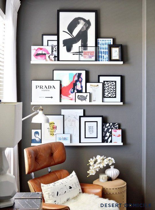 a small and glam gallery wall with white ledges and colorful and fun artworks is a lovely idea for a feminine or jsut glam space