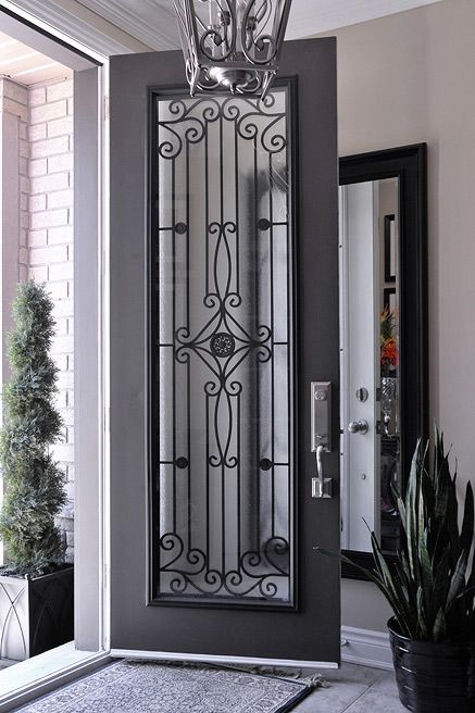 black iron door with a wrought insert