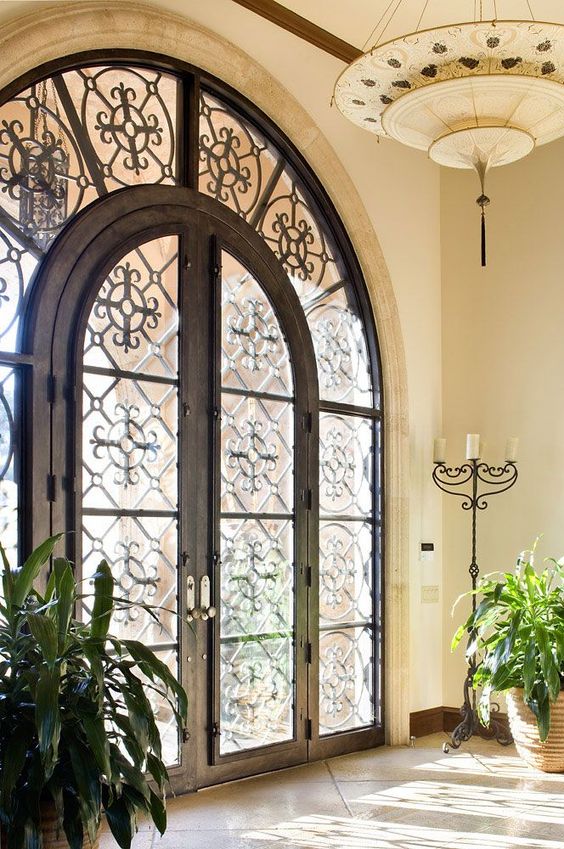 Arched glass and wrought iron front door