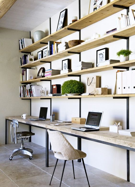 raw wood shelves and desktops supported by iron brackets with shearling desk chair