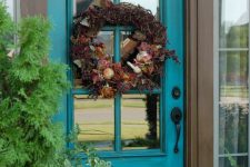 11 teal glass front door with a wreath fro decor and privacy