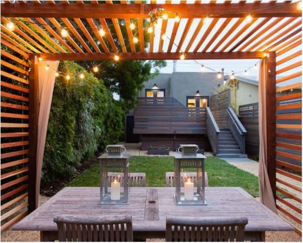 15 pergola dining area with draperies and lights hanging from above