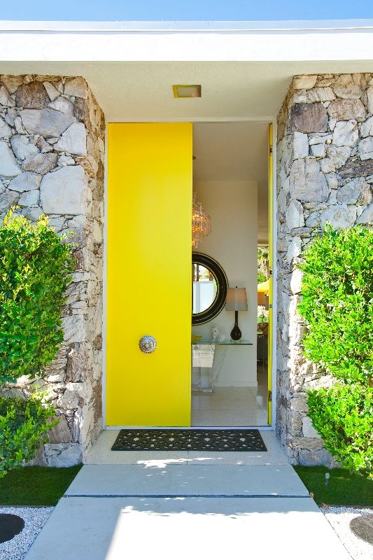 bold yellow front doors with antique handles