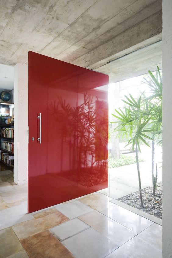 oversized bold red paneled front door