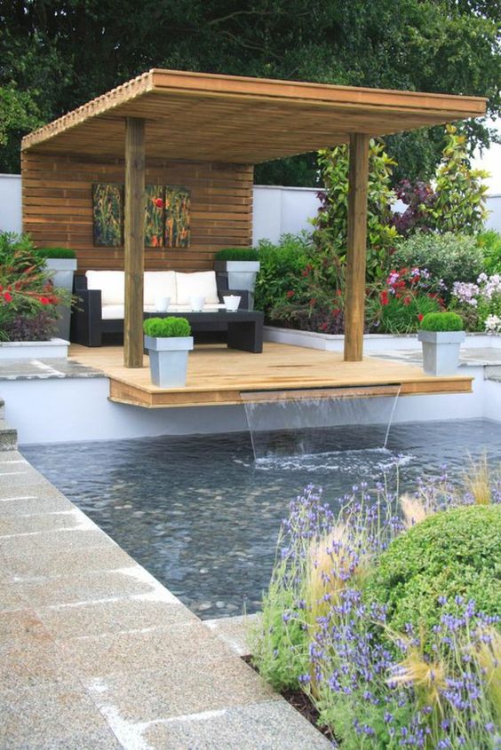 extended gazebo with a pool waterfall