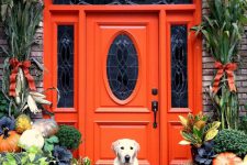 24 vintage orange front door with a glass pane and pumpkins highlighting it