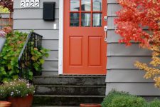 26 bold orange front door and a tree with orange leaves