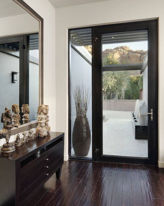 modern glass framed door with a sidelight