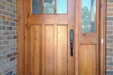 28 stained tan wooden door with one sidelight