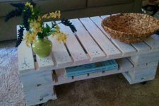 DIY whitewashed pallet coffee table with a storage shelf