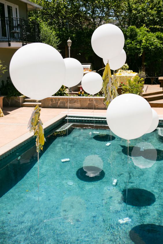 white balloons over the pool for an airy feel