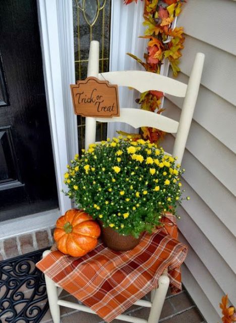 a vintage chair for displaying mums and a pumpkin