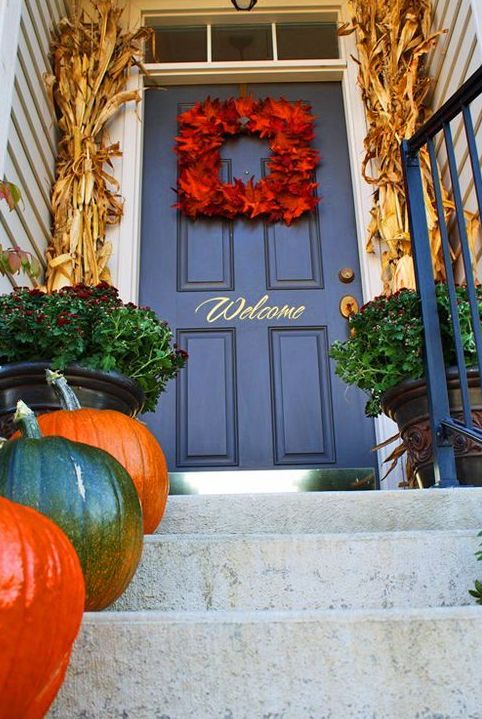 framing a door with corn stalks, a bold leaf wreath and nautral pumpkins