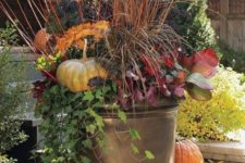 06 fall container arrangement with fall plants and flowers, pumpkins stacked around