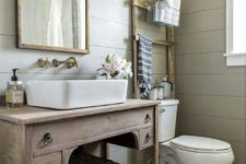 a large basket with a lid to store towels can be placed in a rustic or farmhouse bathroom, you can put it on a shelf or a vanity