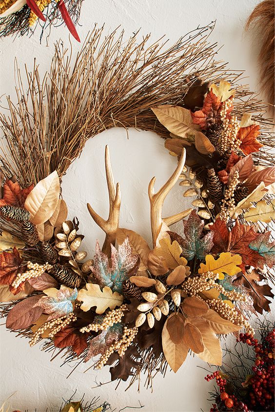 bushel of natural rattan, finished with pinecones, autumn-hued leaves and faux antlers