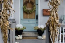 08 corn husks, white and pale green pumpkins, a wreath and potted flowers