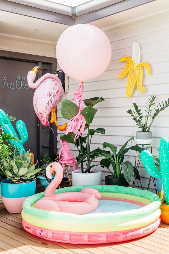 small pool, bold summer-inspired balloons and floats