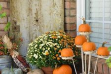 12 vintage plant stand for pumpkins and a wood trolley as a lardy fall-inspired display