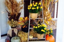 13 vintage ladder as a potted mums display and pumpkins