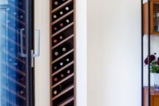 18 walnut wine rack is slotted discretely into the living room wall