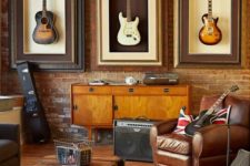 24 framed guitars displayed in a music room