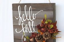 25 wooden sign decorated with faux berries, leaves and pinecones