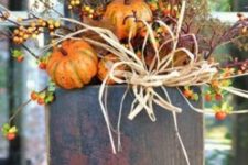 26 outdoor doorbox stuffed with pumpkins and branches