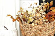 a basket with bright fall leaves and a faux pumpkin will be nice fall decorations, you can place them anywhere