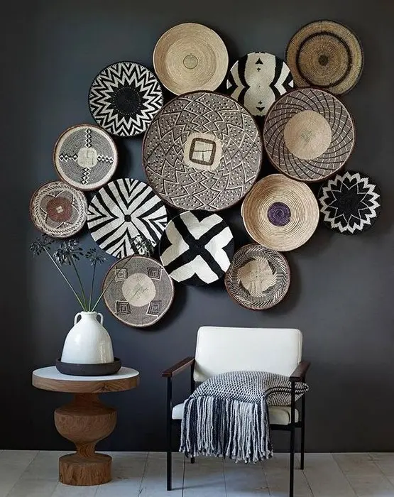 a dark space is enlivened with white furniture and graphic painted baskets on the wall