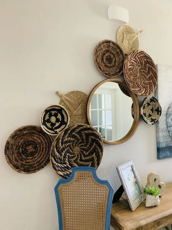 a gallery wall of painted baskets, a round mirror is a cool decoration for a boho space, make one yourself