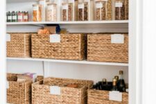 a pantry styled with basket cubbies and glass jars with wooden lids is a lovely and cozy space that welcomes