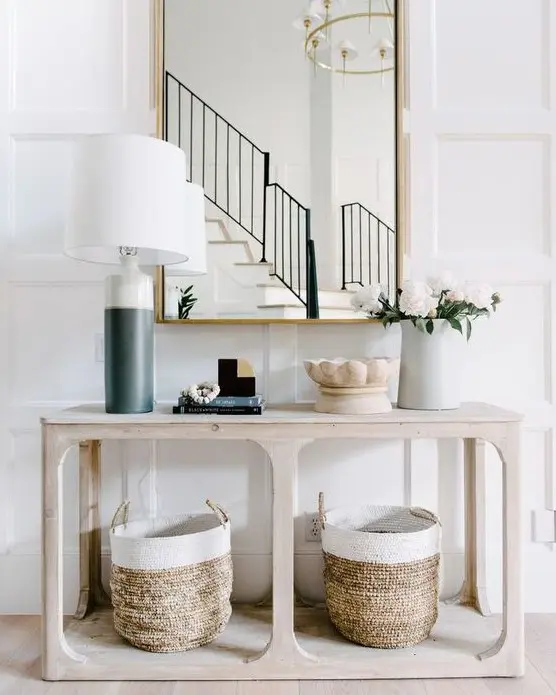 a simple wooden console table and two matching baskets for storage are very comfy and give a cozy feel to the space