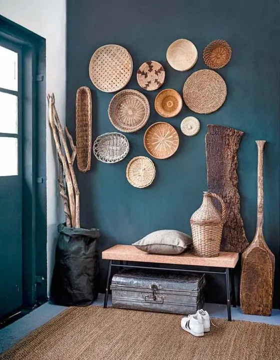 a teal wall and cool baskets that echo with a jute rug and a cork bench