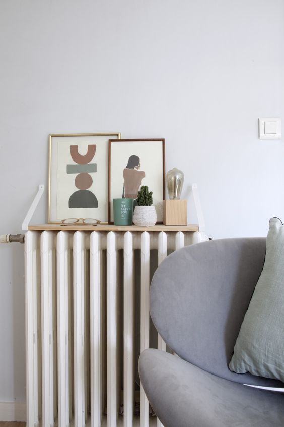 a tiny hanging shelf with decor and potted plants is a lovely solution for a Scandinavian space