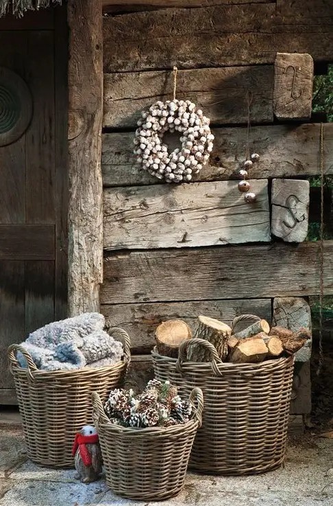 baskets with pinecones, firewood and blankets for decorating a winter porch