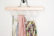 DIY scarf and accessory hanger from a pants holder and shower curtain rings