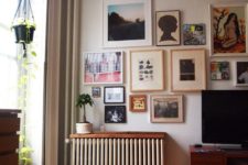 a small stained shelf installed over the radiator looks cohesive in the space and doesn’t distract attention from the gallery wall