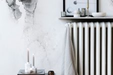 a narrow wall-mounted display shelf above the radiator is a cool idea for a Scandinavian space, it’s a smart and cool idea