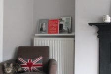 a picture ledge over the radiator to hold magazines and books is a smart way to use this small space to advantage