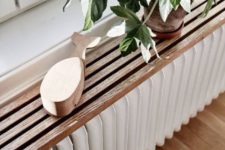 a fluted plant shelf over the radiator is a super trendy and cool idea, everything fluted is totally on right now