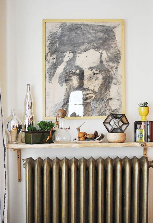 a small shelf over the radiator and lots of things displayed on this shelf are so eye catchy that no one sees the radiator itself