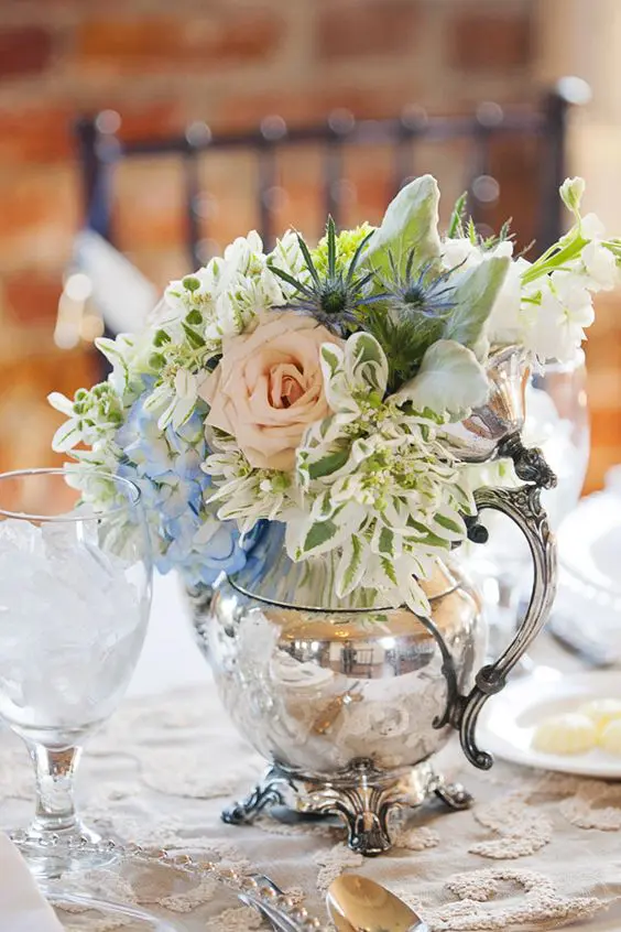vintage silver teapot filled with flowers, great idea for a centerpiece at a tea party