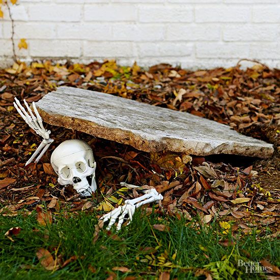 pieces of a plastic skeleton make a creepy entrance in this simple outdoor Halloween décor idea