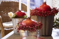 14 centerpiece in a bucket with berries, pomegranates and candles