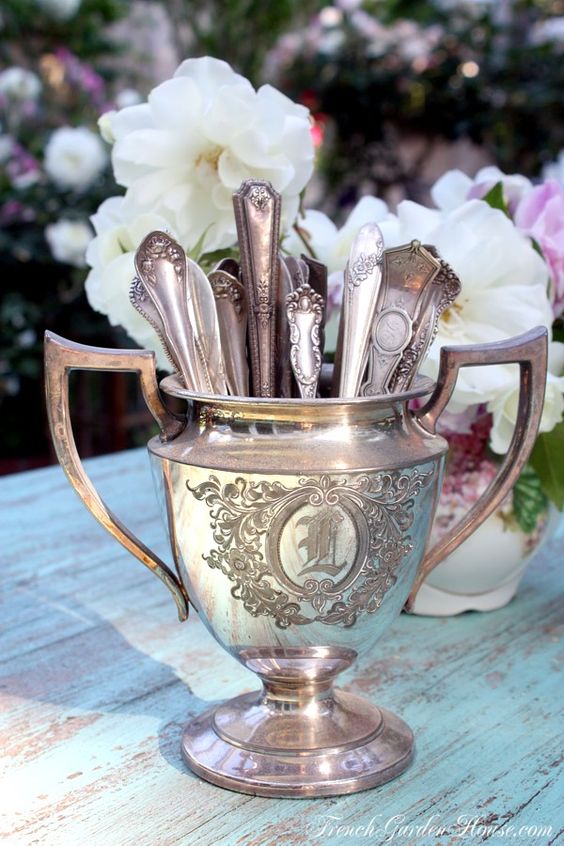 mismatched antique teaspoons in an antique silver sugar bowl