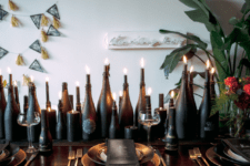 15 chalkboard bottles used as candle holders create a magical table runner