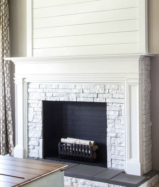 faux fireplace decorated with real bricks and firewood