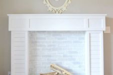 18 traditional-looking faux fireplace with white brick and firewood